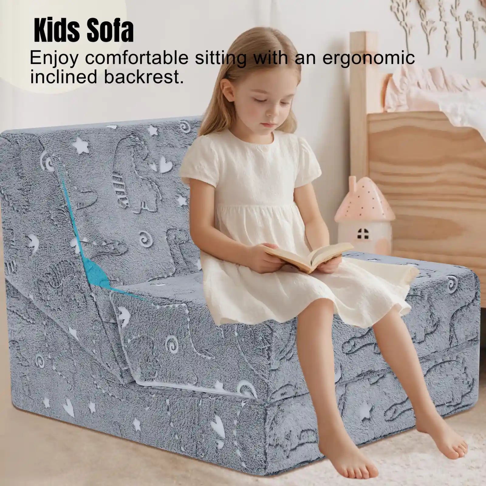 Girl sitting on ergonomically designed Glowsofa's Glowing Dinosaur Children's Fold Out Sofa