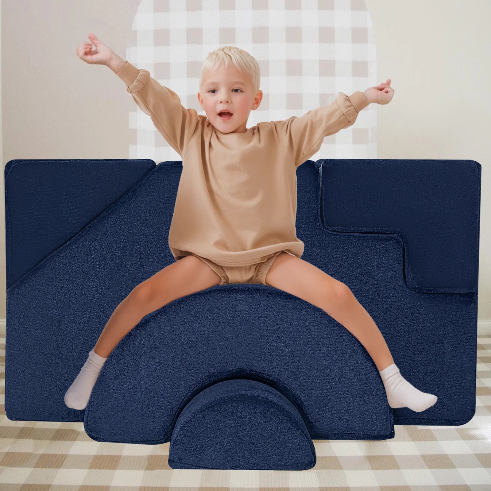 Boy sits and plays on Glowsofa's Solid Navy Climbing Kids Play Couch