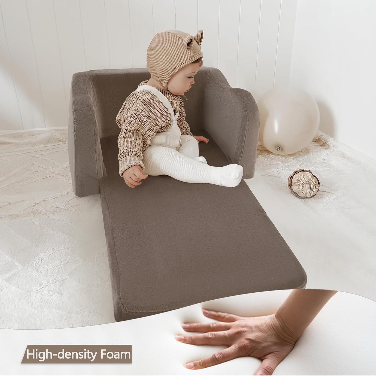 Baby sitting on unfolded Glowsofa's Brown Children's Fold Out Sofa