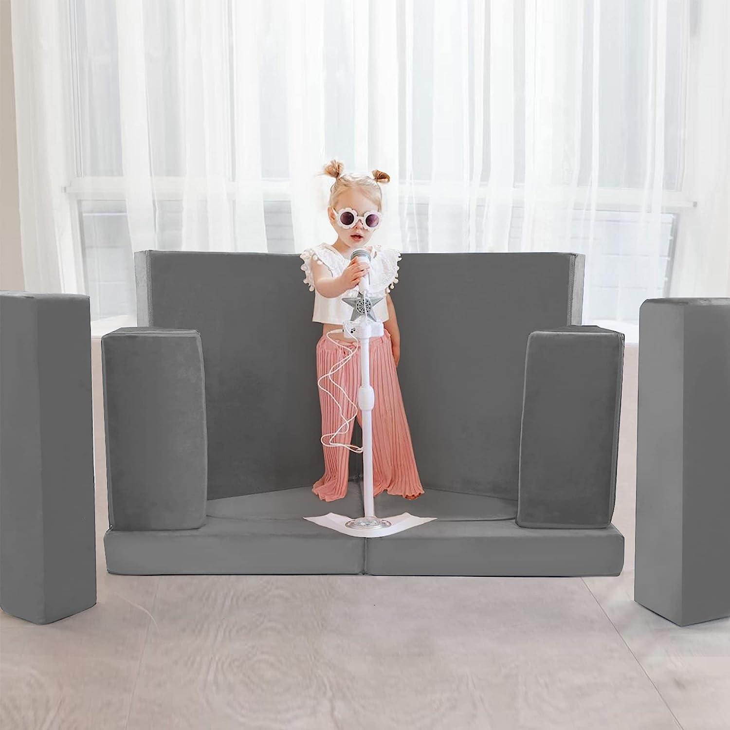 Girls singing on a small stage built by Soild grey kids paly couch