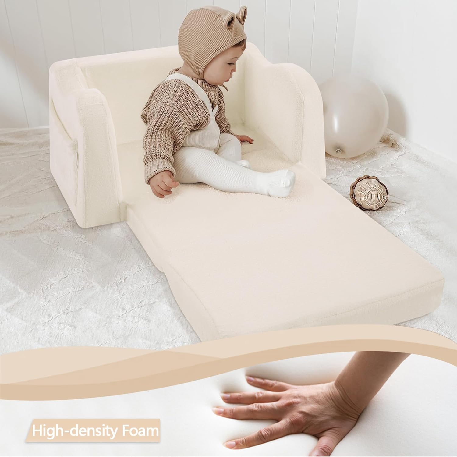 Baby sitting on Glowsofa's Beige Children's Fold Out Sofa filled with high-density foam