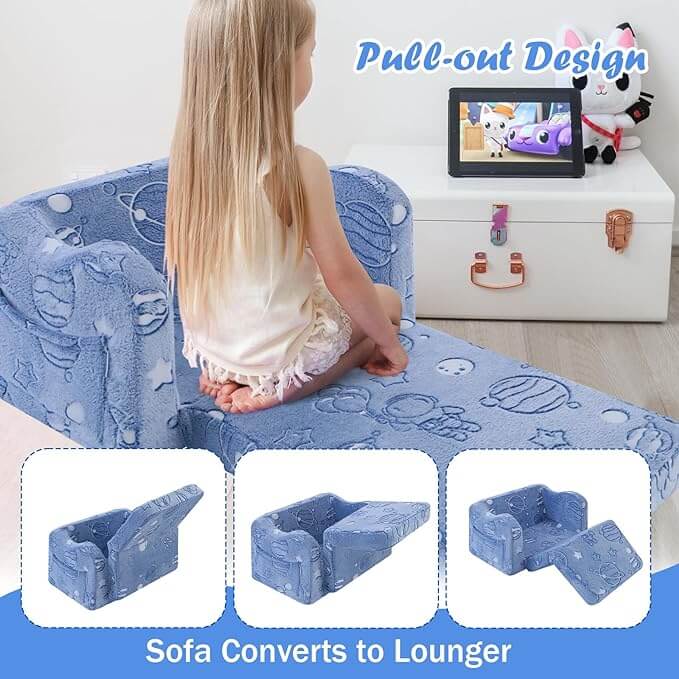 Baby sitting on unfolded Glowsofa's Glowing Space Children's Fold Out Sofa watching cartoons