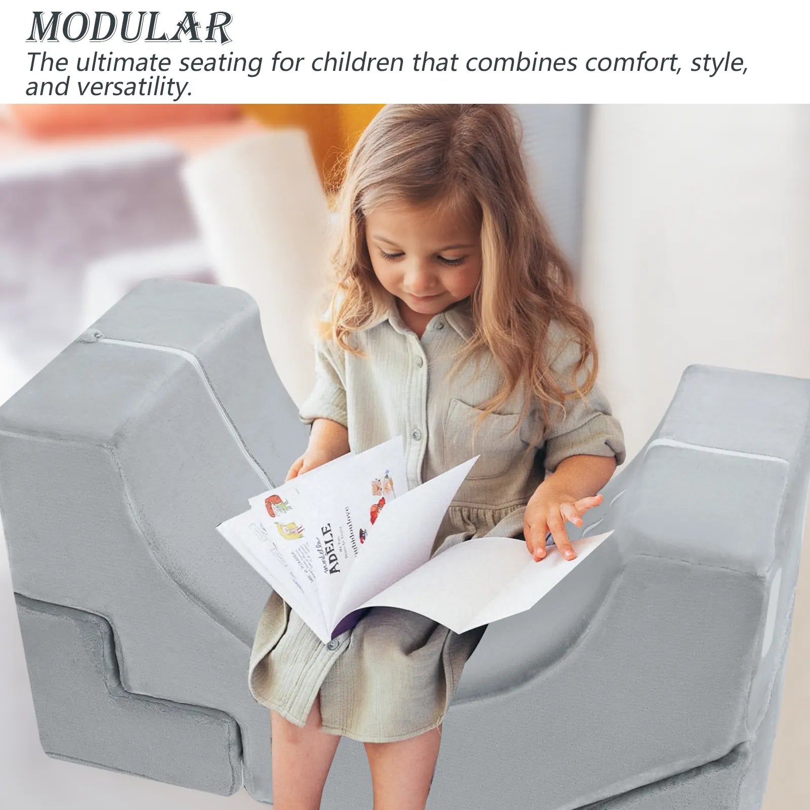 Girl reading a book while sitting on a U-shaped kids chair made up of Glowsofa's Solid Grey Climbing Kids Play Couch