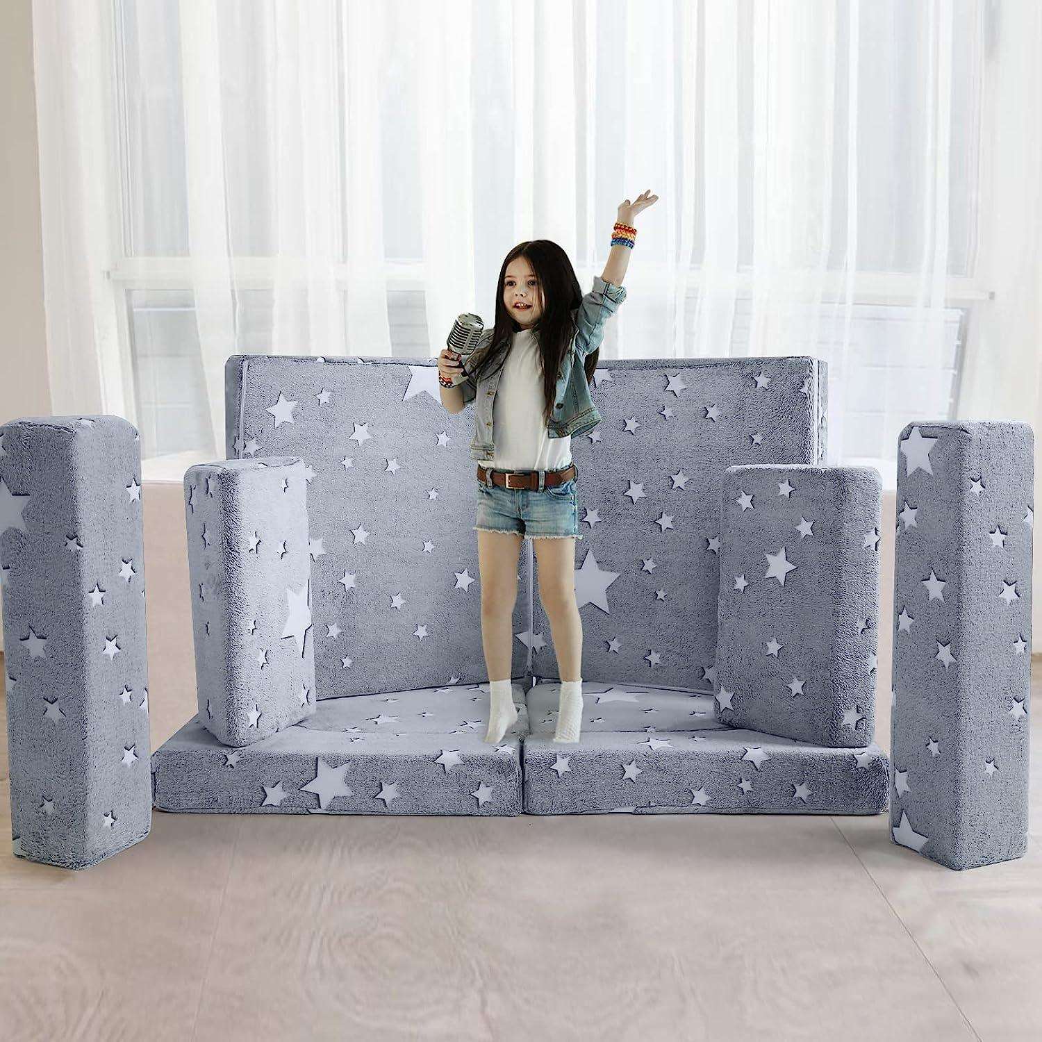 Girls singing on a small stage built by Glowing star kids paly couch