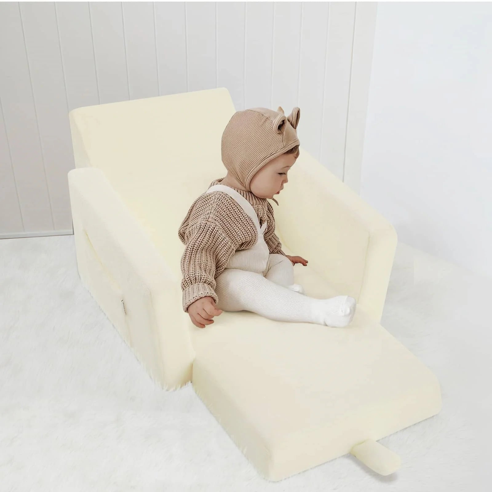 Little boy sitting on Children's fold out sofa-Beige