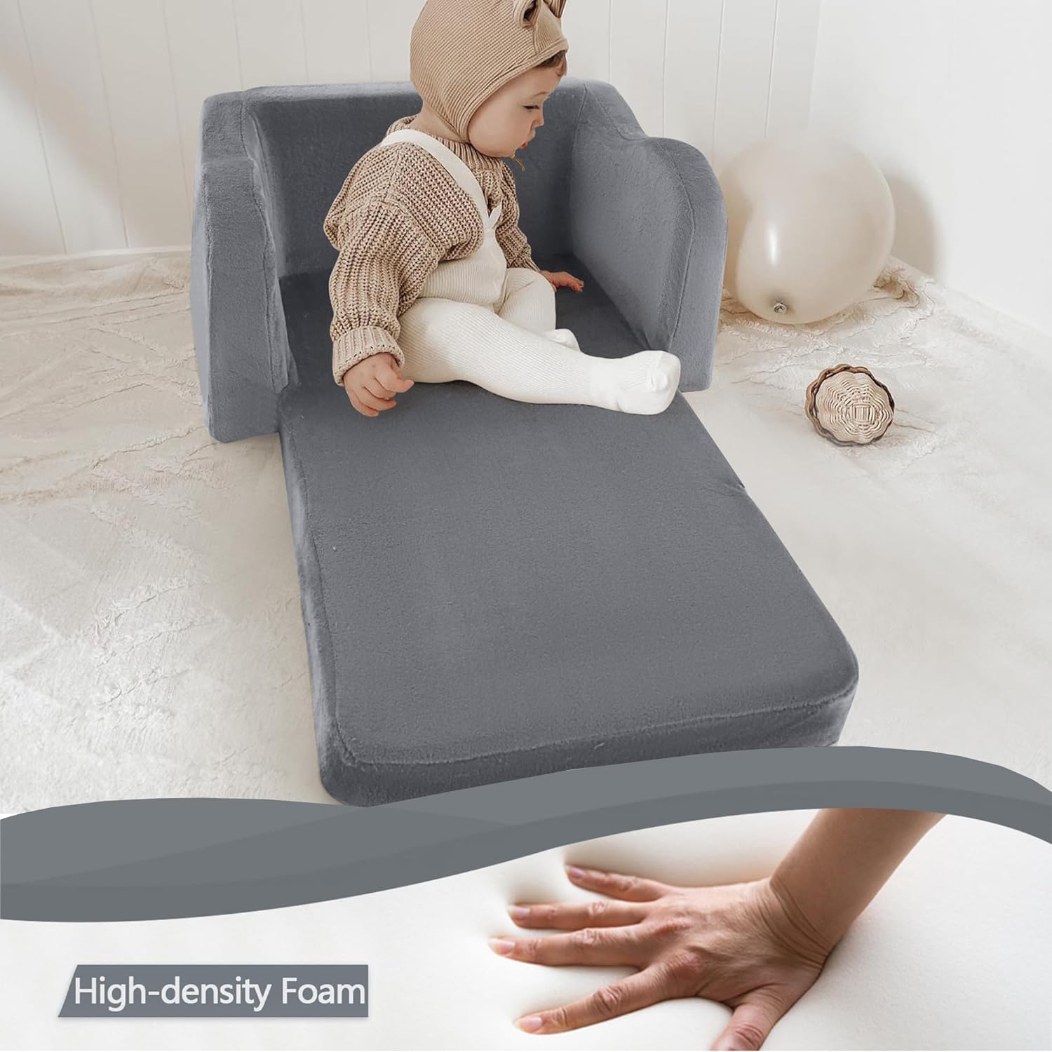 Baby sitting on unfolded Glowsofa's Grey Children's Fold Out Sofa