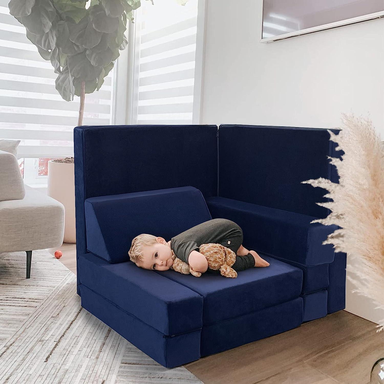 A little boy lying on a Solid Navy kids paly couch.
